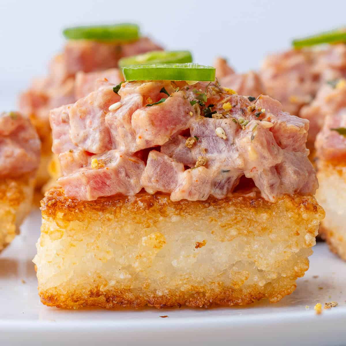 Crispy rice squares topped with spicy tuna and jalapeno