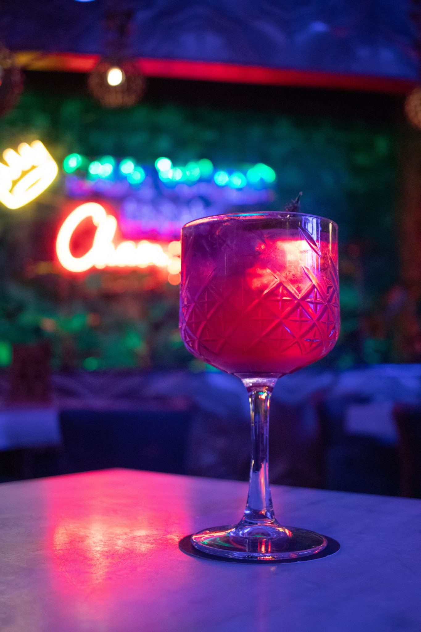 Close-up of a colorful cocktail in a trendy bar setting