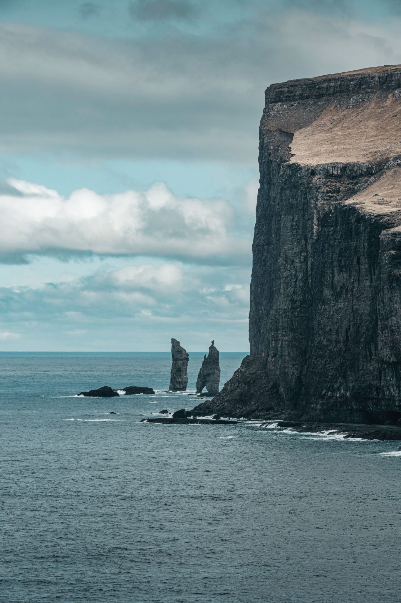 Dramatic cliffs meeting the ocean in the Faroe Islands