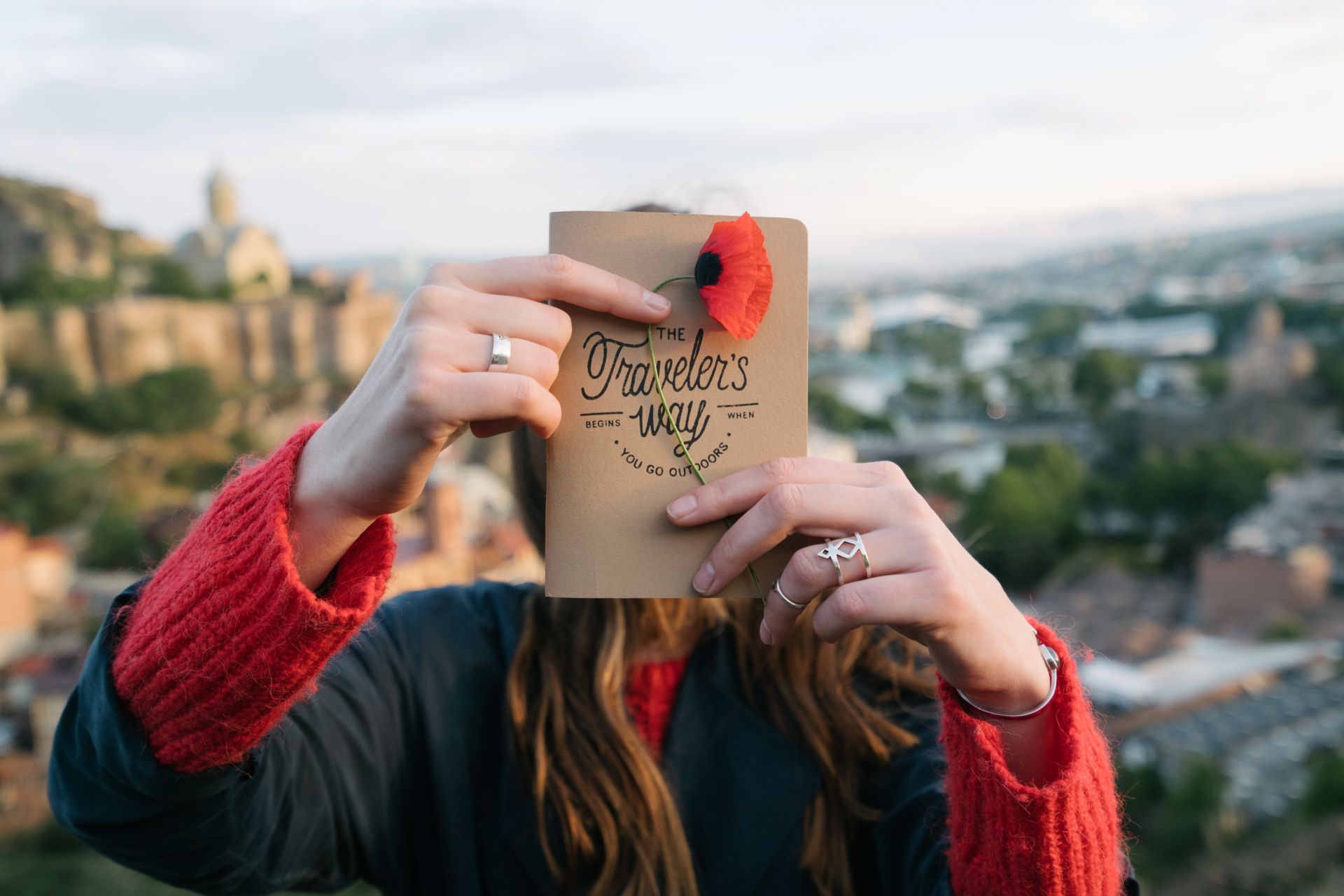Traveler holding a travel guidebook outdoors