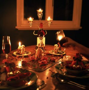 Candlelit dinner table set with wine glasses for a romantic date night