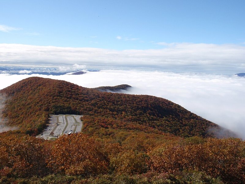 Autumn-colored ridges rise above a sea of morning clouds at Brasstown Bald, the highest point in Georgia