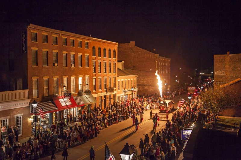 Crowds line historic Main Street in Galena, Illinois, at night during the annual Halloween parade