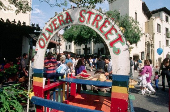 The colorful Olvera Street entrance arch in downtown Los Angeles with visitors walking along the historic marketplace