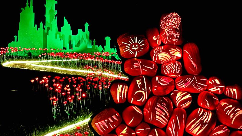 Glowing hand-carved jack-o'-lanterns arranged into large illuminated sculptures at night at the Great Jack O'Lantern Blaze in Croton-on-Hudson, New York
