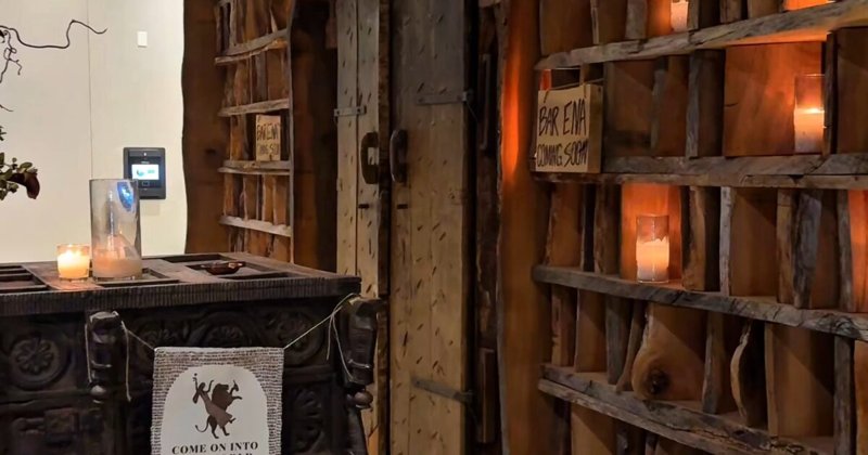 Interior of Bar Ena with carved wood details and warm lighting