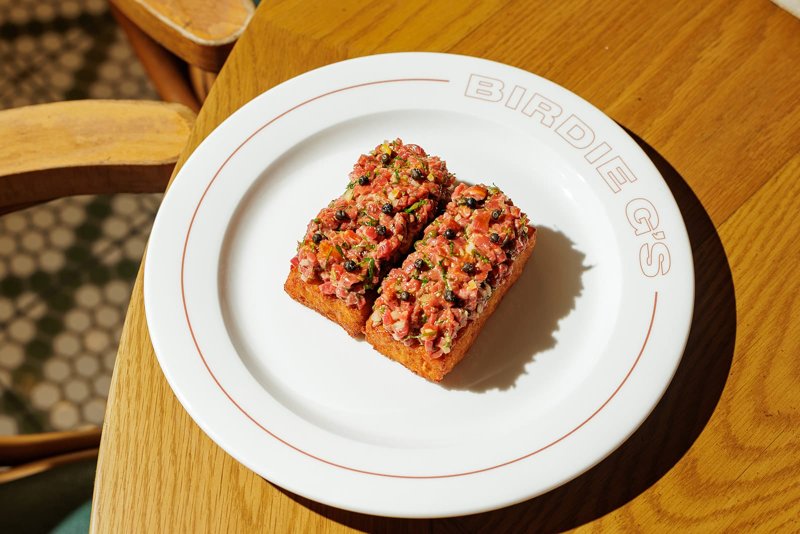 A plated dish on a Birdie G's branded plate at the Fairmont Century Plaza
